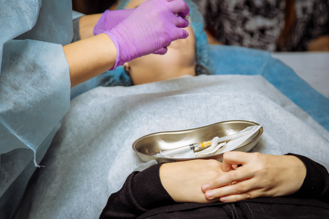 A patient prepared for a dermal fillers session, showcasing sterile tools and professional care for facial rejuvenation.